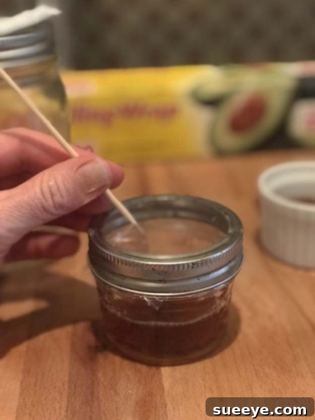 DIY Fruit Fly Trap - Natural Way to Get Rid of Fruit Flies in Kitchen or Bar Using a toothpick, poke small holes into the cling wrap of your DIY fruit fly trap, allowing pests to enter but trapping them inside.