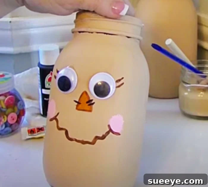 DIY Scarecrow Mason Jar Craft for Fall Decor - Easy Dollar Tree Project featuring painted face