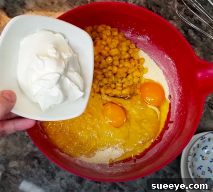 Easy Corn Casserole 2 Preparing the Jiffy Corn Casserole Mixture in a Mixing Bowl - Easy Corn Casserole Recipe