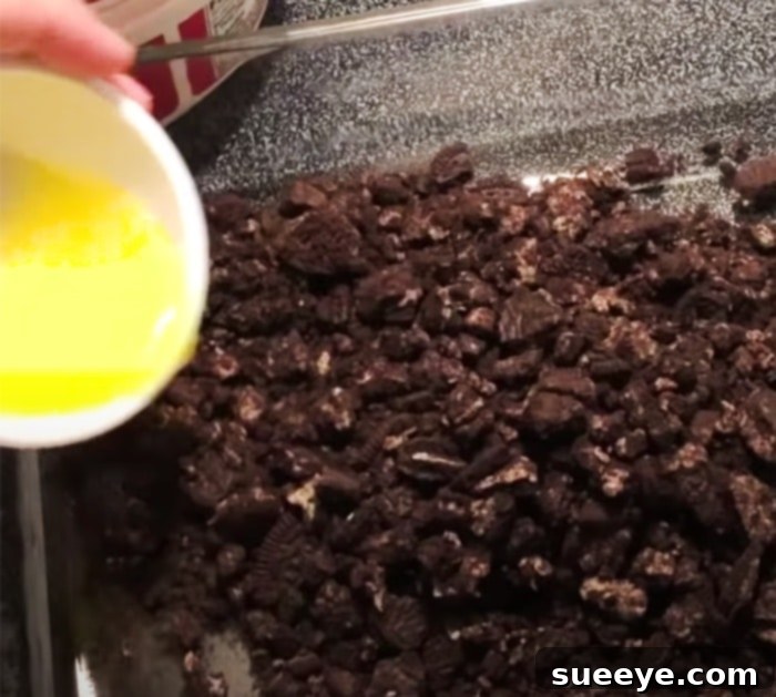 Decadent No-Bake Chocolate Peanut Butter Bars 2 No-Bake Chocolate Peanut Butter Dessert Recipe - Step 1: Layering the Peanut Butter Fluff over Oreo Crust