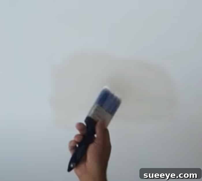 Fixing Peeling Flaking And Bubbling Paint 3 Easy DIY Hack To Fix Peeling Paint - Repair Bathroom Ceiling Paint - Repair Kitchen Paint - A freshly painted and repaired ceiling section in a bathroom, looking immaculate and brand new.