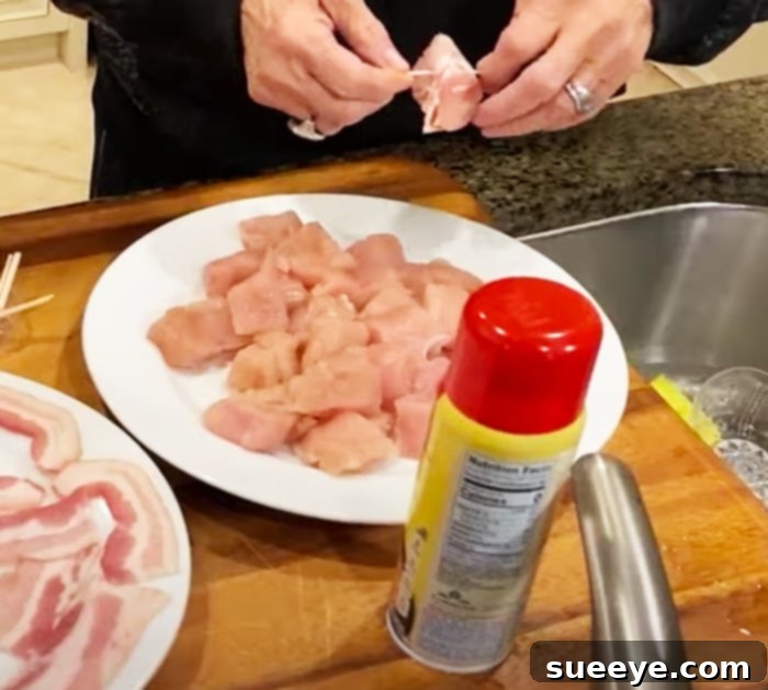 Paula Deen's Crispy Air Fryer Bacon-Wrapped Chicken Bites 2 Prepare succulent bacon-wrapped chicken bites, an easy appetizer recipe perfect for any gathering, featuring juicy chicken and crispy candied bacon.