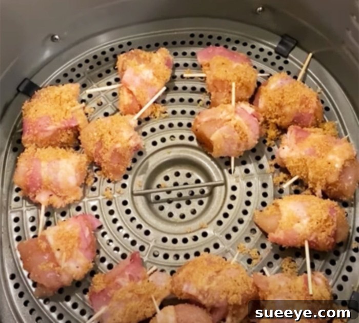 Paula Deen's Crispy Air Fryer Bacon-Wrapped Chicken Bites 3 Crispy air fryer bacon-wrapped chicken bites, a flavorful appetizer recipe with a sweet and spicy glaze. Perfect for parties and easy to make.