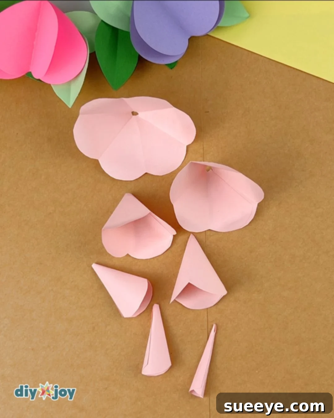 Image demonstrating the gluing and curling of the remaining petal pieces.